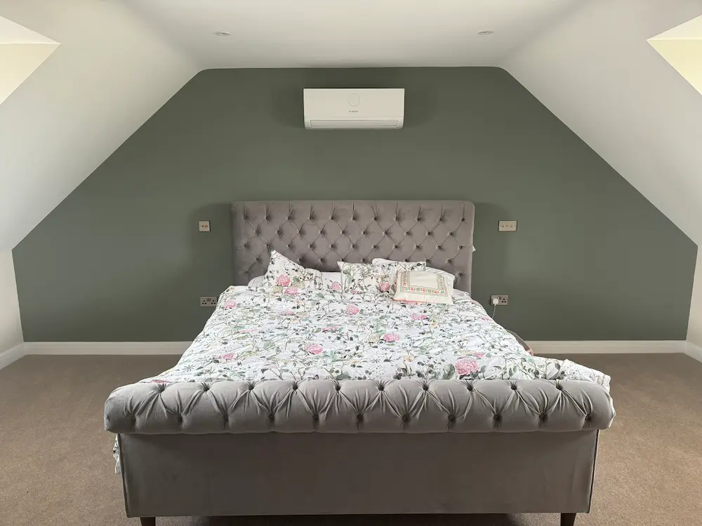 Wall mounted air conditioning unit fitted in a bedroom